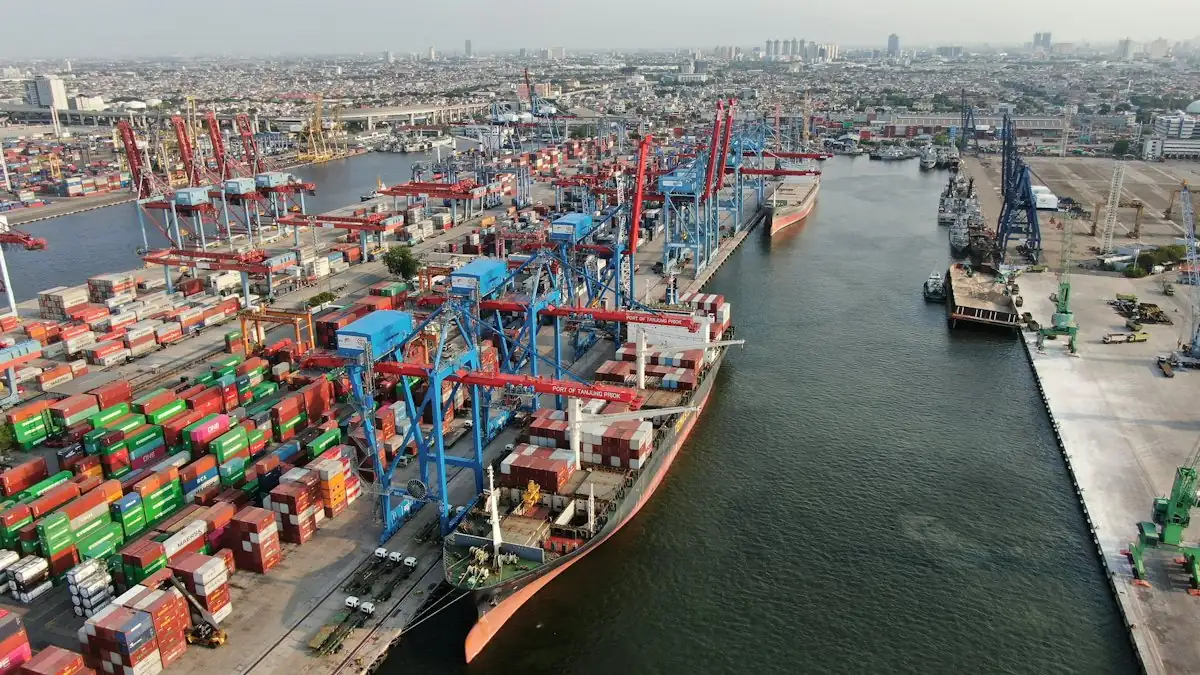 Container ship being worked at a busy port with cranes